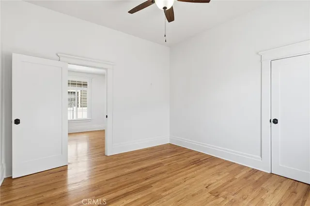 a view of empty room with wooden floor