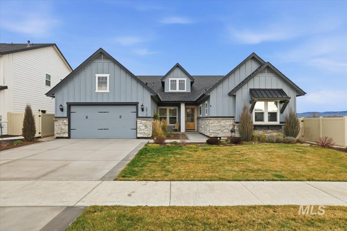 2910 East Brace Street Meridian, ID 83642 - Photo 1 of 1 View of front of property featuring board and batten siding, stone siding, driveway, and a garage