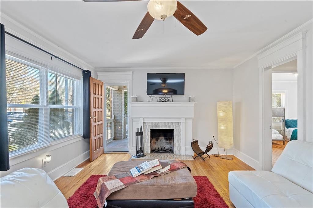 a bedroom with a bed couch and a large window
