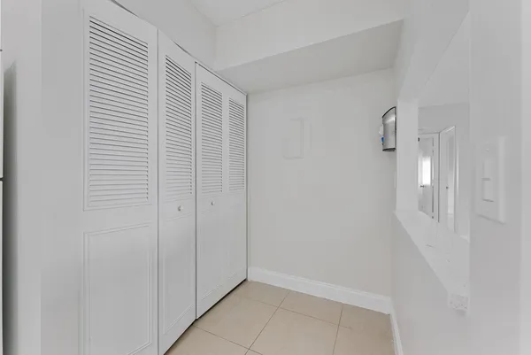 a view of storage and utility room with closet