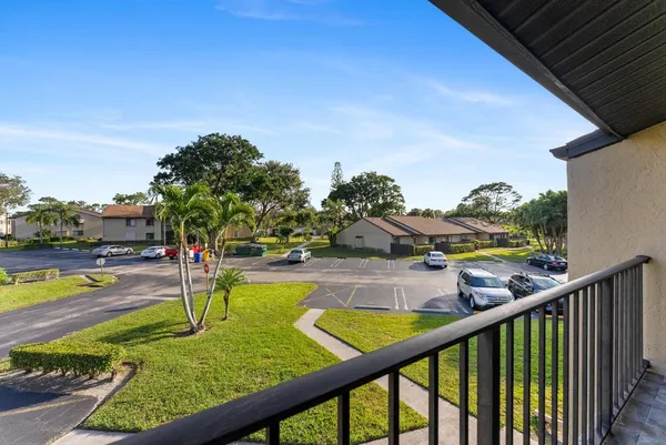 a view of a hallway with wooden floor and entryway