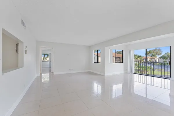 a view of an empty room with glass door