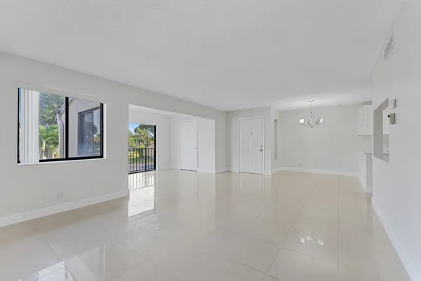 a view of a kitchen with a sink and a refrigerator