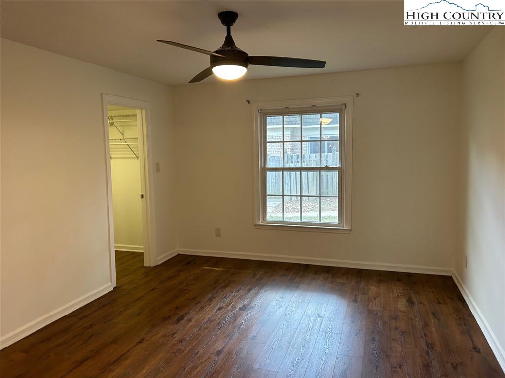 3520 Colony Road, Unit F Charlotte, NC 28211 - Photo 13 of 18 an empty room with wooden floor fan and windows