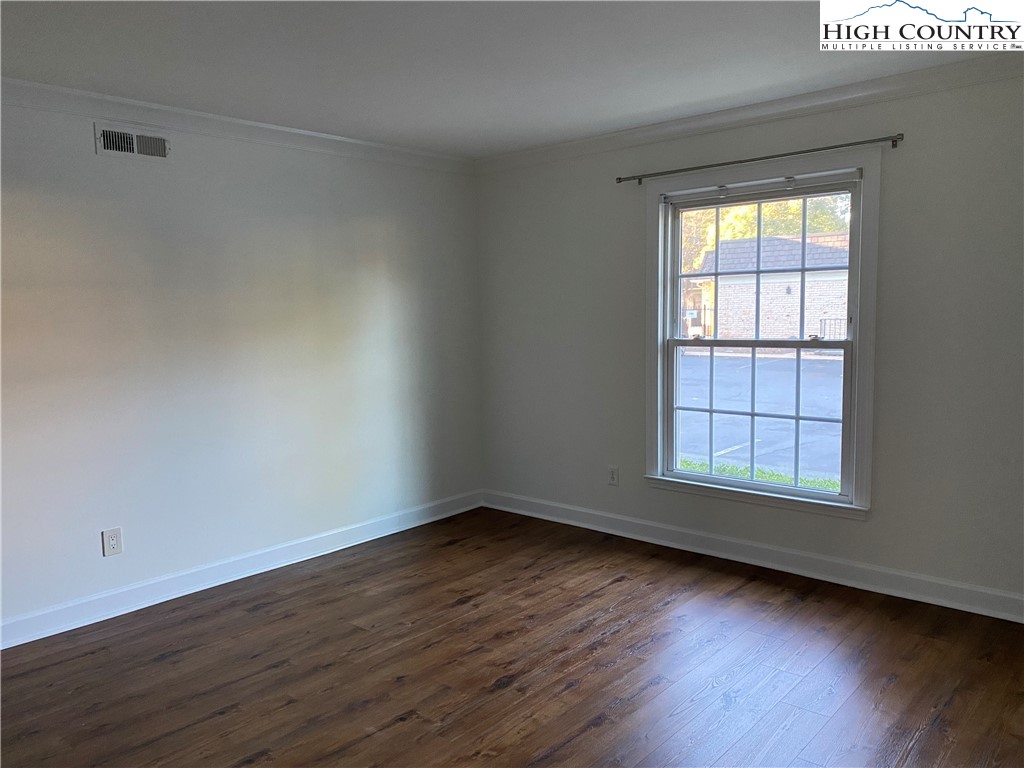 3520 Colony Road, Unit F Charlotte, NC 28211 - Photo 3 of 18 an empty room with wooden floor and windows