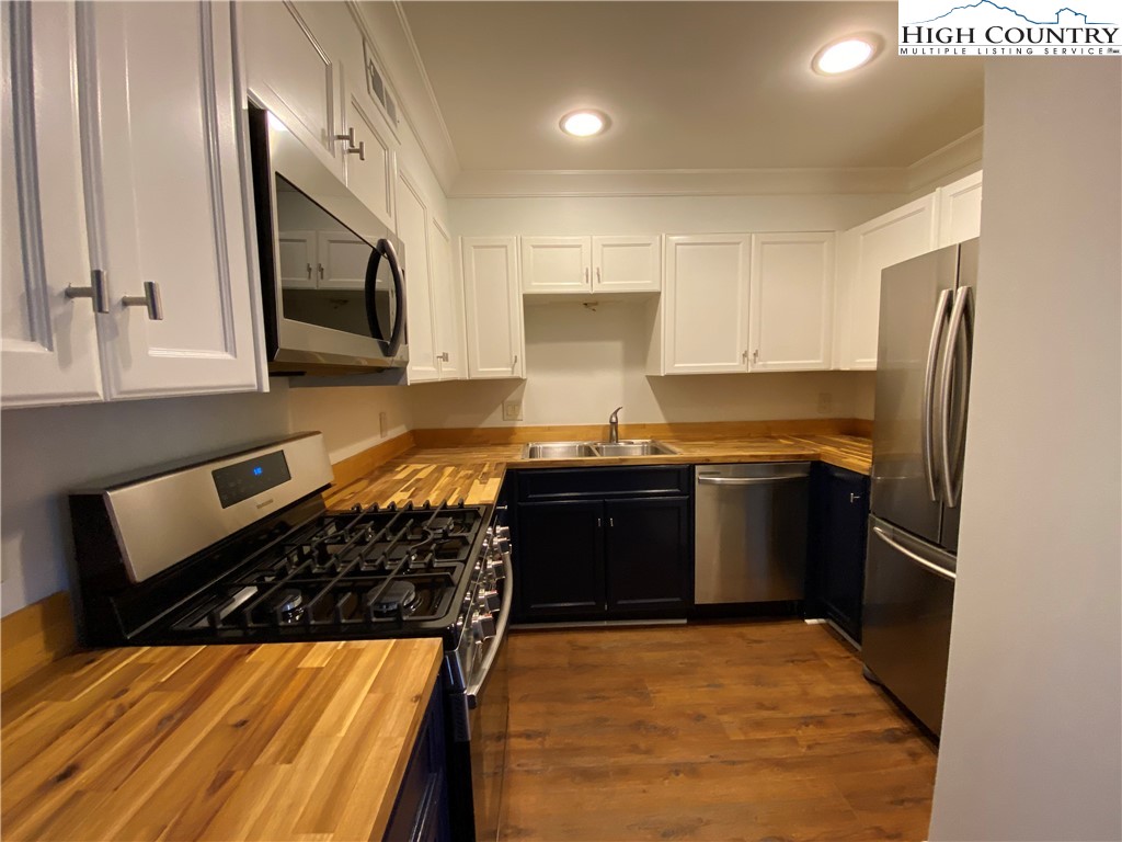 3520 Colony Road, Unit F Charlotte, NC 28211 - Photo 10 of 18 a kitchen with refrigerator sink and cabinets