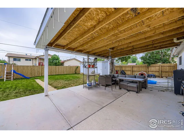 a view of a backyard with sitting area