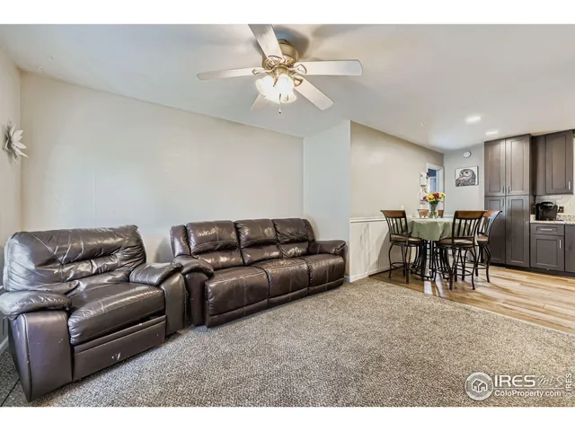 a living room with furniture and kitchen view