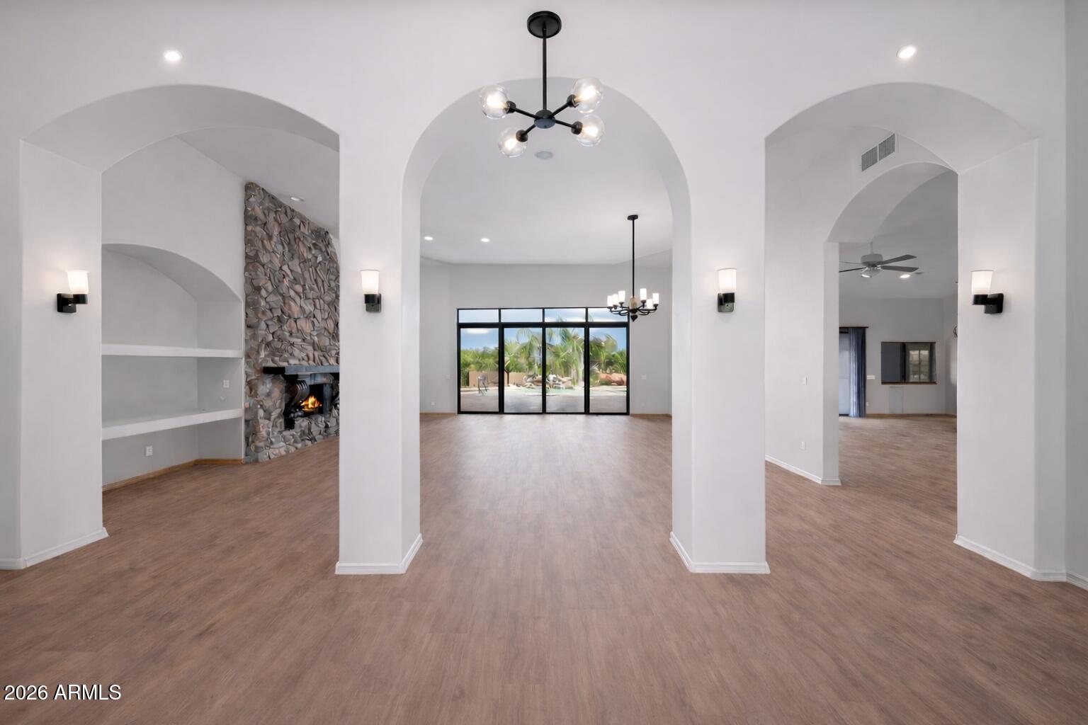 6646 East Lone Mountain Road Cave Creek, AZ 85331 - Photo 11 of 37 a view of a hallway with wooden floor and a living room