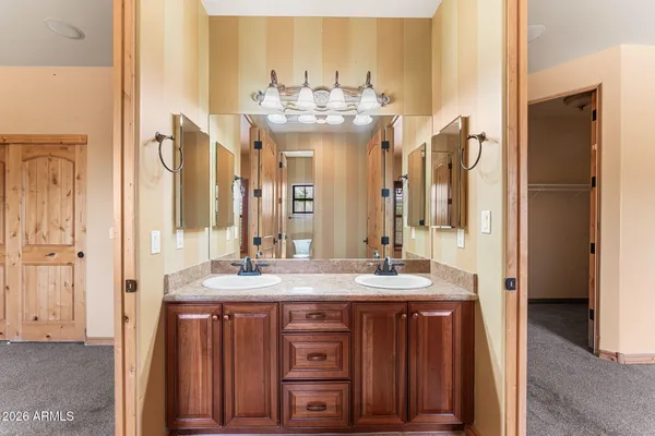 a bathroom with a sink vanity granite and shower