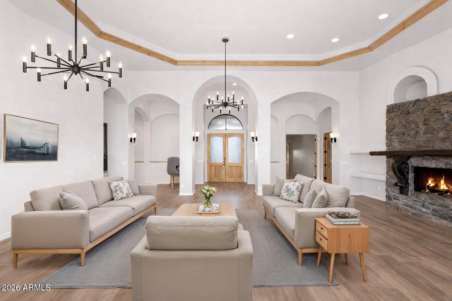 6646 East Lone Mountain Road Cave Creek, AZ 85331 - Photo 7 of 37 a living room with furniture a fireplace and a chandelier