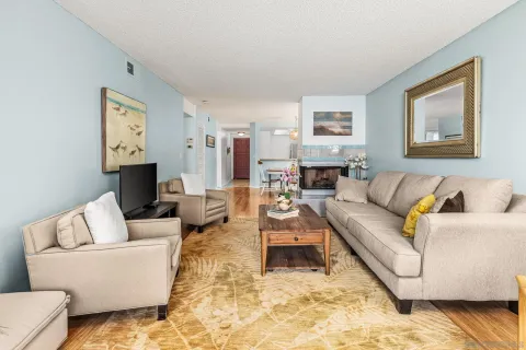 a living room with furniture and painting on the wall