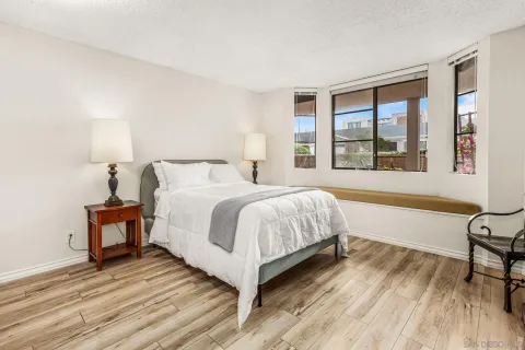 a spacious bedroom with a bed and a large window