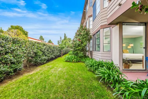 a view of a house with a backyard and a garden