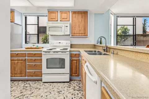 a kitchen with a stove sink and cabinets
