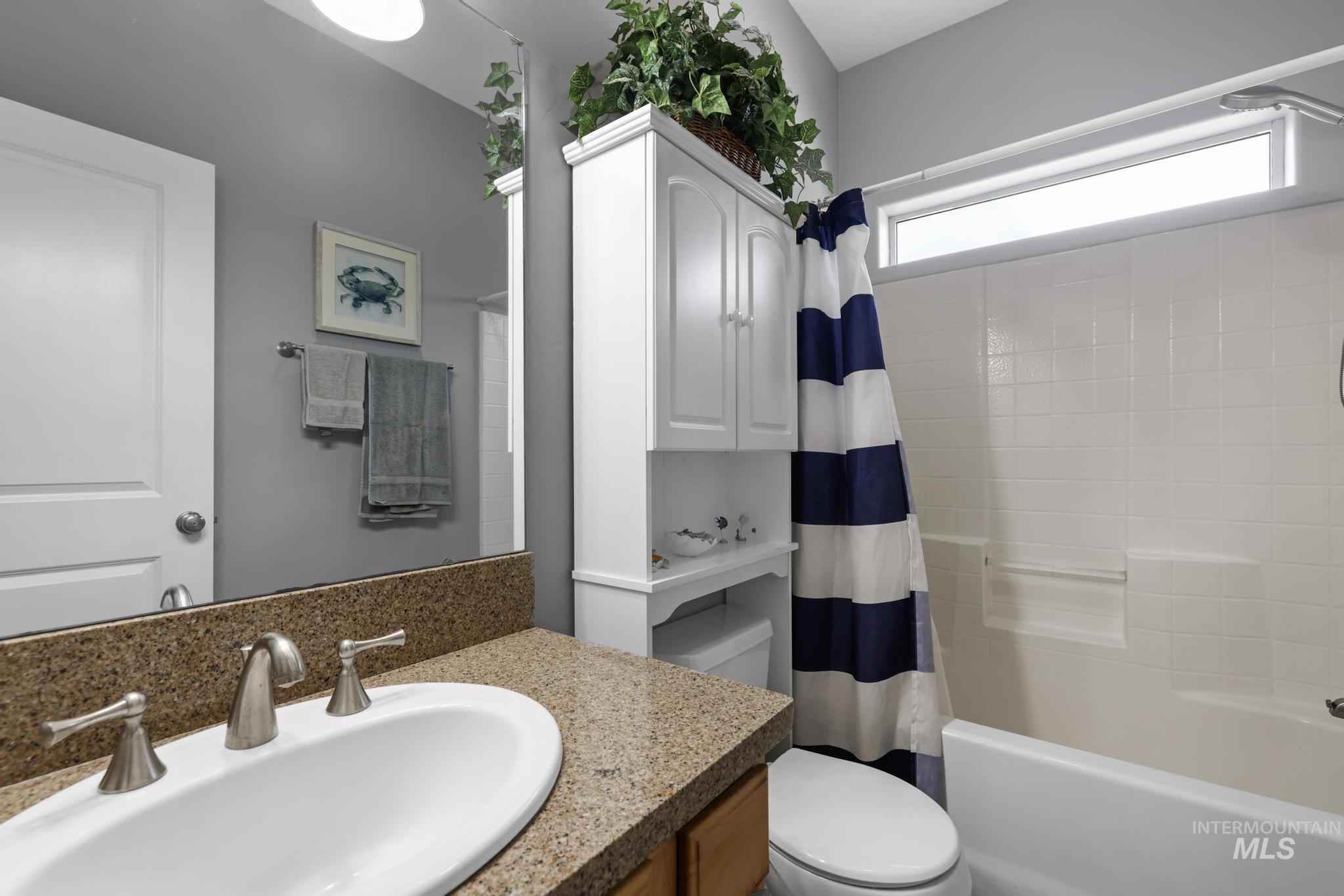 467 Wildrose Loop Twin Falls, ID 83301 - Photo 20 of 46 Bathroom featuring a white vanity with granite-finish countertop, dual-handle faucet, and built-in white cabinetry