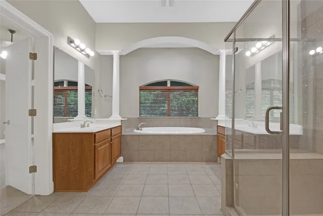 a large spacious bathroom with a large tub shower and sink