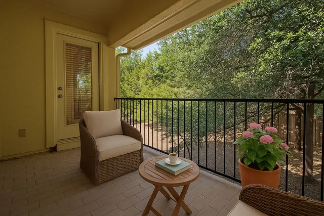 a balcony with furniture and a potted plant