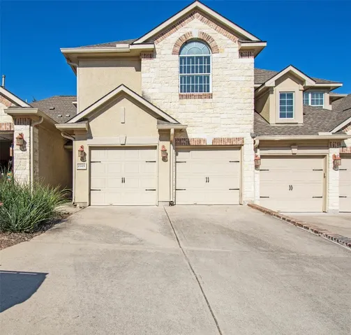 a view of a house with a yard and garage