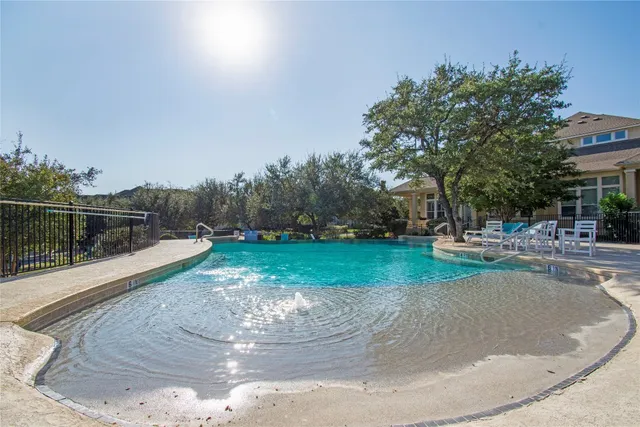 a view of a swimming pool with a yard