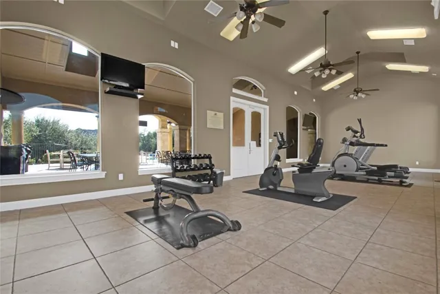 a room with gym equipment and a large window