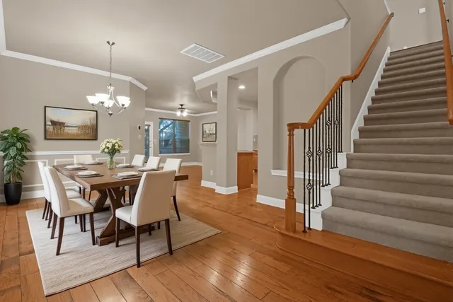 a view of a dining room with furniture and wooden floor