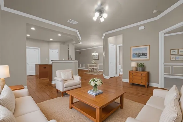 a living room with furniture and wooden floor