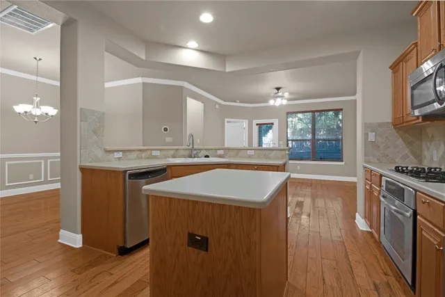 a kitchen with granite countertop a sink and a stove top oven