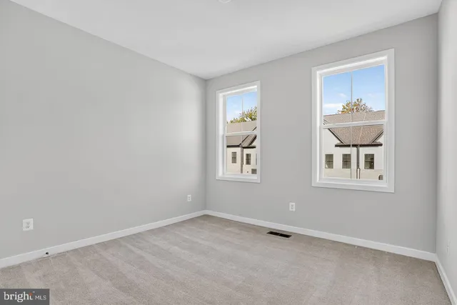 an empty room with windows and closet