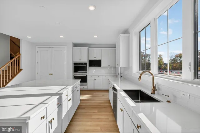 a view of a kitchen with a sink and windows