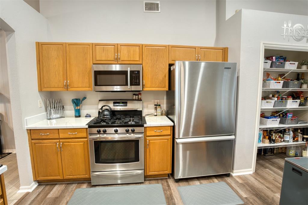 4303 Orange Ridge Court Valrico, FL 33596 - Photo 24 of 40 a kitchen with refrigerator a stove and a microwave