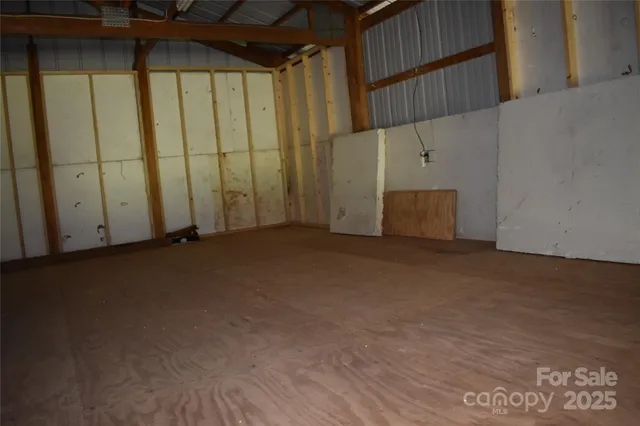 a view of a yard with plants and tree