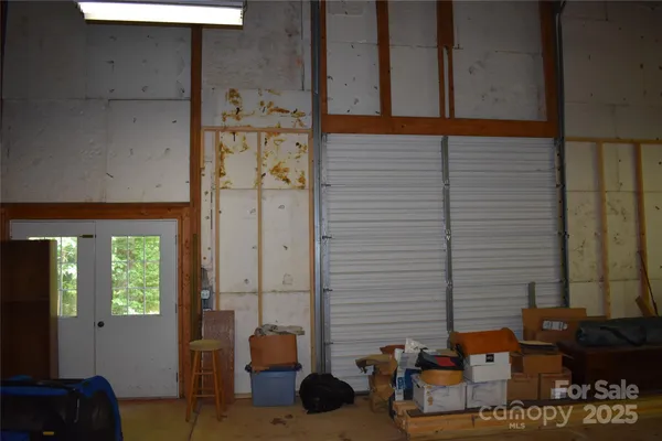 a view of a yard with table and chairs and wooden fence