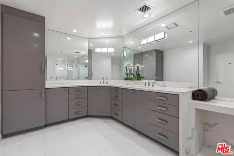 a bathroom with a sink double vanity and a mirror