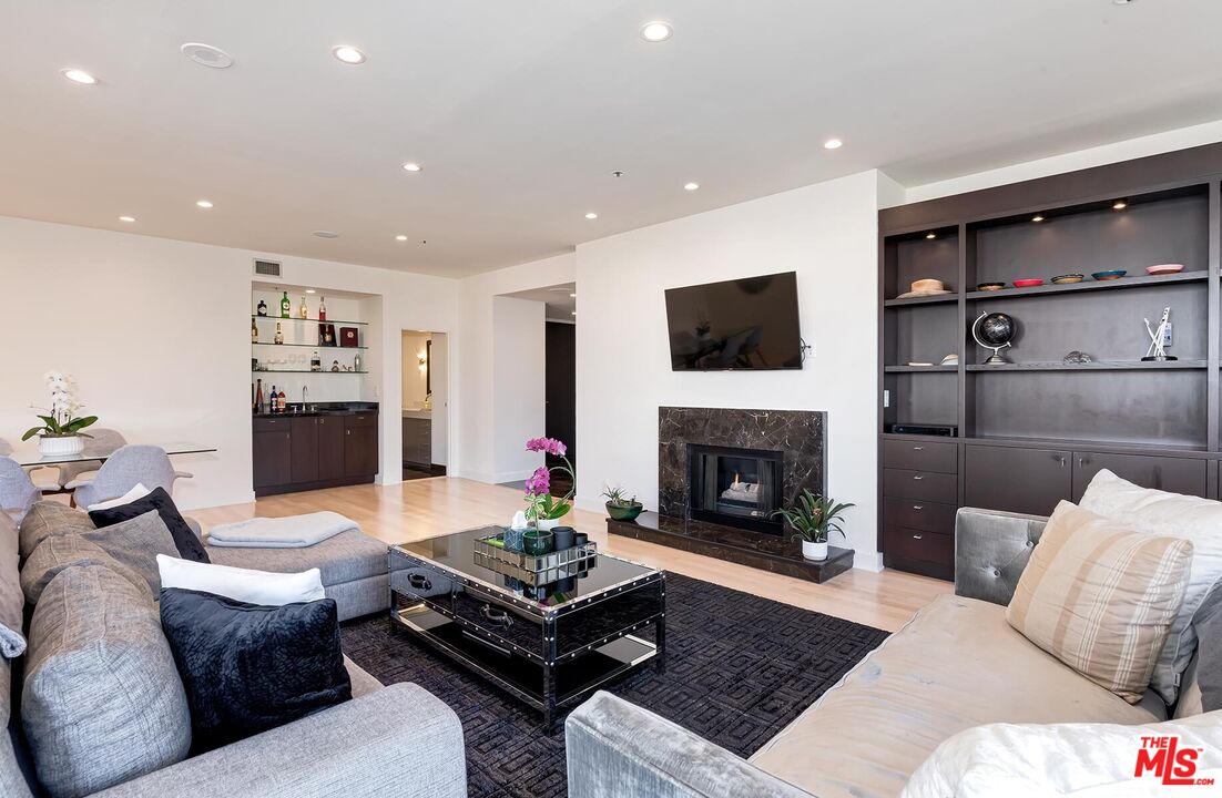 10430 Wilshire Boulevard, Unit 803 Los Angeles, CA 90024 - Photo 2 of 23 a living room with furniture and a fireplace