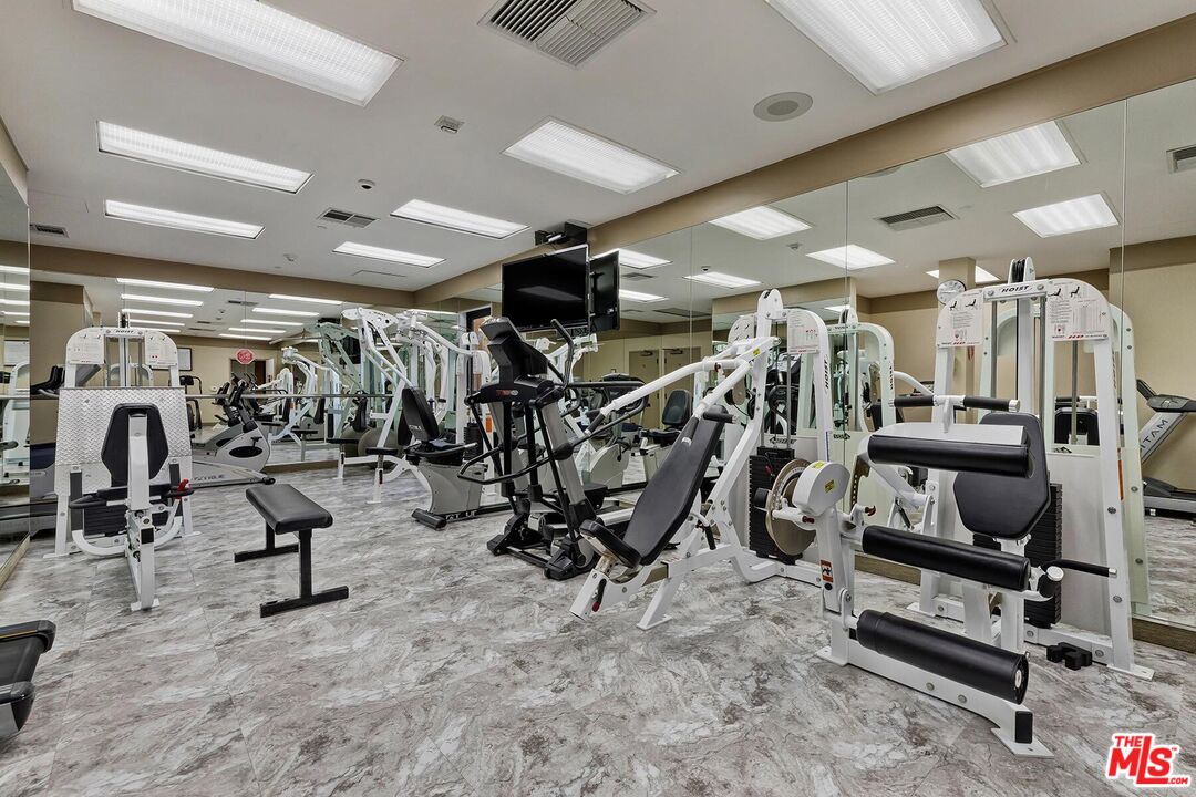 10430 Wilshire Boulevard, Unit 803 Los Angeles, CA 90024 - Photo 21 of 23 a view of a room with gym equipment