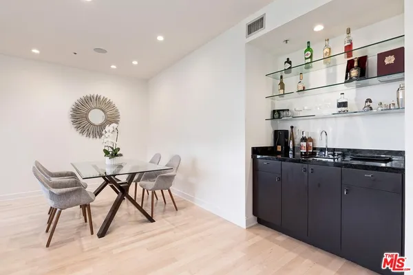 a kitchen with stainless steel appliances granite countertop a sink and a refrigerator