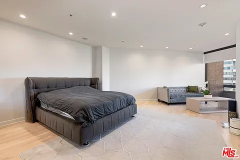 a spacious bedroom with a large bed and furniture