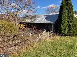 a view of house with yard and sitting area