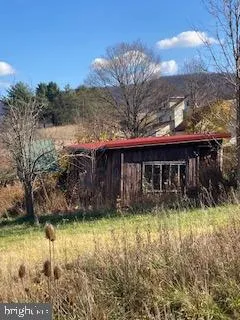 a view of a house with a yard balcony and tree