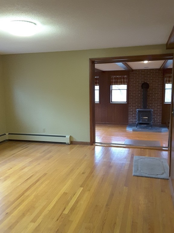 82 Monson Turnpike Road Ware, MA 01082 - Photo 11 of 29 an empty room with wooden floor and windows