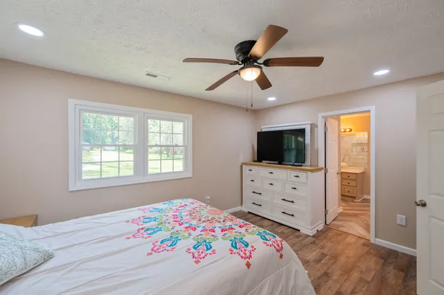 a bedroom with a bed and a flat screen tv