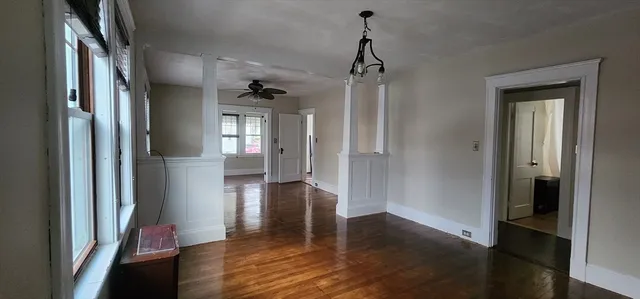 a view of a hallway view with wooden floor and staircase
