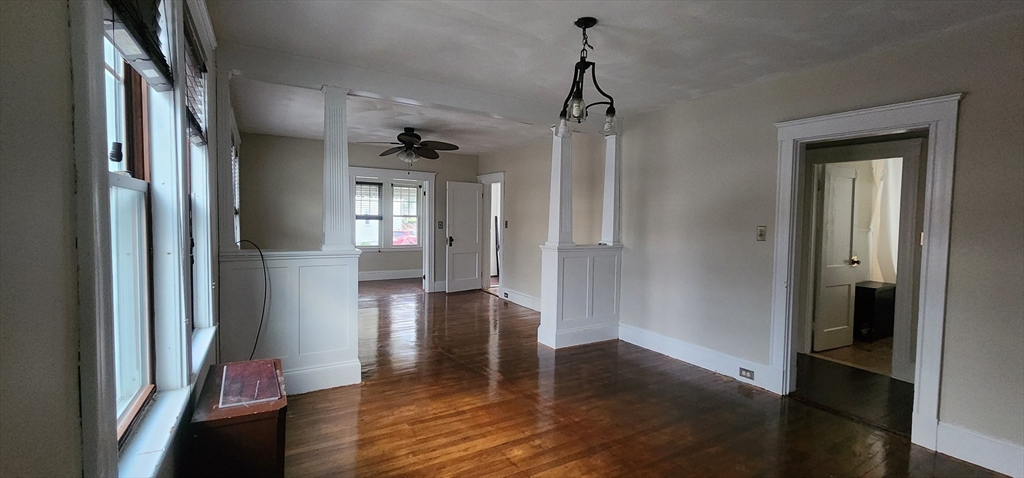 a view of a hallway view with wooden floor and staircase