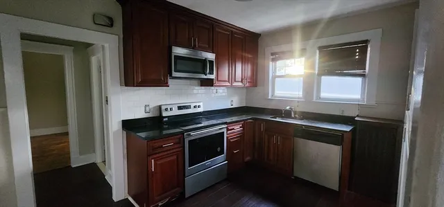 a kitchen with a sink stove and microwave