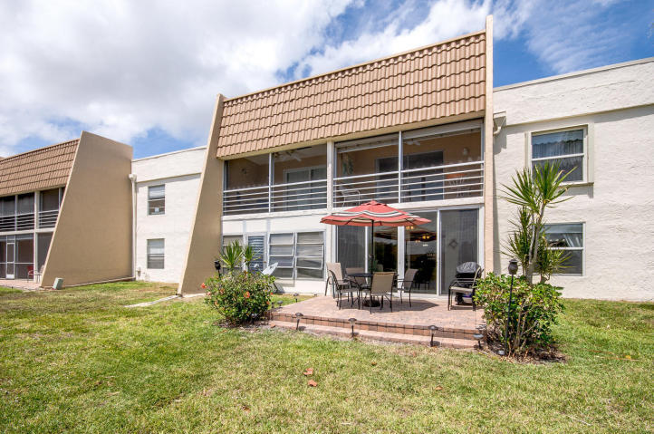 2901 Fiore Way, Unit 103 Delray Beach, FL 33445 - Photo 22 of 29 a view of a house with backyard porch and sitting area