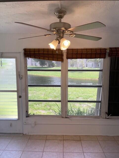 2901 Fiore Way, Unit 103 Delray Beach, FL 33445 - Photo 23 of 29 a view of a room with a large window and chandelier