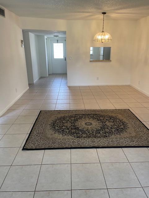 2901 Fiore Way, Unit 103 Delray Beach, FL 33445 - Photo 24 of 29 a view of a hallway with wooden floor