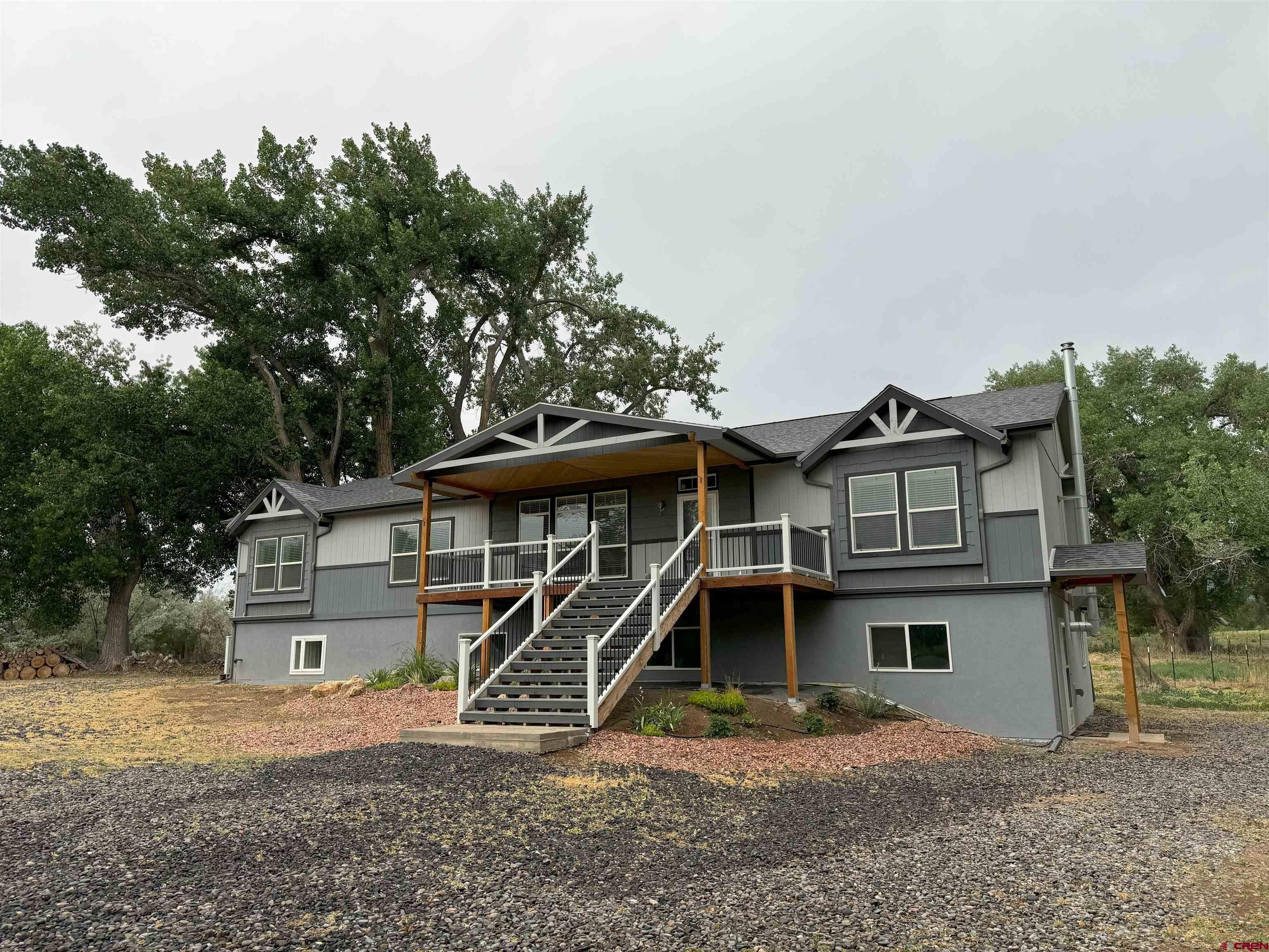 21357 Knight Road Austin, CO 81410 - Photo 1 of 35 a front view of a house with a yard