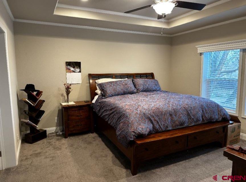 21357 Knight Road Austin, CO 81410 - Photo 17 of 35 a large bed sitting in a bedroom next to a window